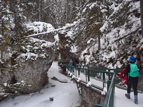 An image of people hiking in Johnston Canyon in winter in Alberta, Canada.