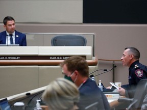 Councillor Evan Woolley listens as Calgary Police Chief Mark Neufeld answers questions in Calgary City Council Chambers on Thursday, Sept. 10, 2020.
