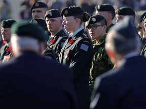 Veterans in the foreground and current armed forces members pay their respects at the cenotaph during Remembrance Day ceremonies at the Military Museums in Calgary on  Saturday November 11, 2017. Let's not forget the dead, but it's the survivors who need our attention most, says columnist Catherine Ford.