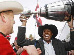 Calgary Stampeders quarterback Henry Burris carries the Grey Cup through a crowd of fans after returning home to a hero's welcome in Calgary Monday, Nov. 24, 2008 after defeating the Montreal Alouettes 22-14 to win the Grey Cup.