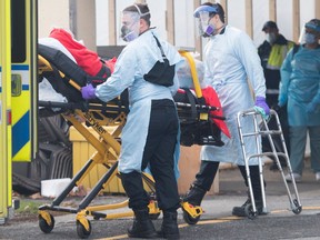 Paramedics transfer a person from Maimonides Geriatric Centre in Montreal, Sunday, November 29, 2020, as the COVID-19 pandemic continues in Canada and around the world.