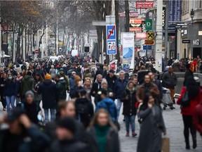 People walk past stores as the Austrian government is due to announce a lockdown including the closure of all non-essential shops, as the spread of the coronavirus disease (COVID-19) continues, in Vienna, Austria November 14, 2020.