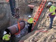 Construction contractors for TC Energy are seen installing a section of the Keystone XL crude oil pipeline at the U.S.-Canada border north of Glasgow, Mont., on April 13, 2020.