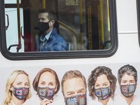 A masked passenger rides a Calgary transit bus on Friday, Nov. 6, 2020.