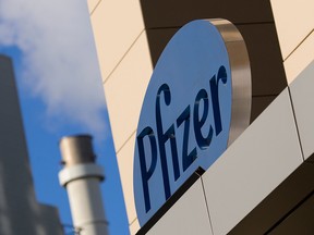 A sign for Pfizer pharmaceutical company is seen on a building in Cambridge, Massachusetts.