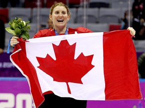 Team Canada's Canada's Hayley Wickenheiser celebrates with a Canadian flag after beating Team USA 3-2 in overtime to win the women's ice hockey gold medal at the Bolshoy Ice Dome at the Sochi 2014 Winter Olympics in Sochi, Russia, on Thursday Feb. 20, 2014. Al Charest/Calgary Sun/QMI Agency OLY2014