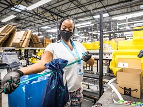 Amazon.com Inc. worker prepares an order in which the buyer asked for an item to be gift wrapped at a fulfillment centre in Shakopee, Minnesota, U.S., Nov. 12, 2020.