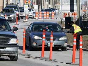 Security helps with directions near the entrance to a COVID-19 drive-thru testing site on King Edward Street in Winnipeg on Sunday, Nov. 1, 2020.