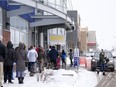 People stand in line to enter the Beacon Hill Best Buy on Boxing Day on Saturday, December 26, 2020.