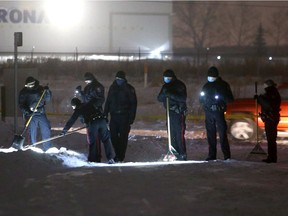 Police are seen investigating the scene along 54th St. SE where a man body was found Saturday morning. Saturday, December 26, 2020. Brendan Miller/Postmedia