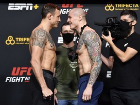 Jack Hermansson of Sweden and Marvin Vettori of Italy face off during their UFC Fight Night weigh-in at UFC APEX in Las Vegas on Dec. 4, 2020.