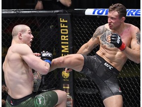 LAS VEGAS, NEVADA - DECEMBER 05: In this handout image from the UFC, Jack Hermansson (R) of Sweden kicks Marvin Vettori of Italy in a middleweight bout during the UFC Fight Night event at UFC APEX on December 05, 2020 in Las Vegas, Nevada.