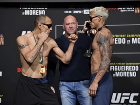 Tony Ferguson (left) and Charles Oliveira face off during the UFC 256 weigh-in at UFC APEX in Las Vegas on Dec. 11, 2020.