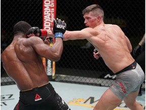 LAS VEGAS, NEVADA - DECEMBER 19: In this handout image provided by UFC, (R-L) Stephen Thompson punches Geoff Neal in a welterweight fight during the UFC Fight Night event at UFC APEX on December 19, 2020 in Las Vegas, Nevada.