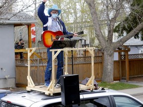 Matt Masters, founder of Curbside Concerts performs on top of his van during a Birthday Party in Calgary on Saturday, May 9, 2020. Darren Makowichuk/Postmedia