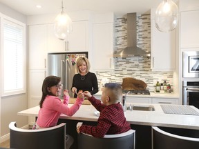 Raelee Dielwart and her children, Violet Nicholson, 7, and Walker Nicholson, 5, love the openness of the floor plan in their new townhome at Wentworth Pointe, by Trico Homes.
