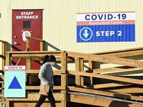 A person walks past a COVID-19 assessment centre during the COVID-19 pandemic in Scarborough, Ont., on Wednesday, December 2, 2020.