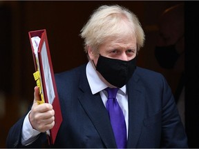 Britain's Prime Minister Boris Johnson wearing a face mask because of the coronavirus pandemic leaves number 10 Downing Street in central London on December 2, 2020, to take part in the Prime Minister Question (PMQs) session in the House of Commons. - Britain's Prime Minister Boris Johnson on Wednesday hailed UK approval for the use of Pfizer-BioNTech's Covid-19 vaccine as "fantastic" news that would help life get back to normal. "It's the protection of vaccines that will ultimately allow us to reclaim our lives and get the economy moving again," he said, after regulators gave the green light in a world first.