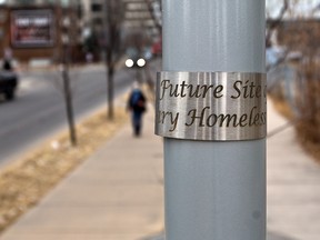 A steel band marks a light post along 13th Avenue in Calgary's beltline that will be the site of a future memorial to those who lost their lives to homelessness in Calgary. The marker was photographed on the longest night of the year, Monday, December 21, 2020, which is an annual memorial day to homeless deaths.