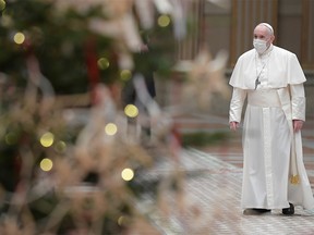 Pope Francis wears a protective mask before delivering his traditional Christmas Day Urbi et Orbi speech to the city and the world virtually from inside the Hall of Blessings instead of from the St. Peter's square in order to limit the number of people gathering due to the coronavirus disease (COVID-19) regulations, at the Vatican, Dec. 25, 2020.