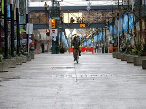 Atul Jain rides his bike on a near-empty Stephen Avenue mall as new COVID restrictions were announced in Calgary on Wednesday, Dec. 9, 2020.