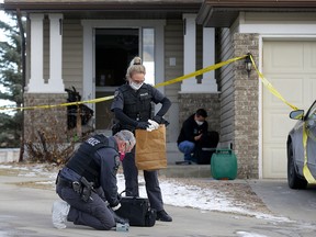 Calgary police investigate a fatal stabbing at a home in the 200 block of Panatella Court N.W. on Dec. 16, 2020.