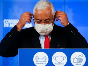 Portugal's Prime Minister Antonio Costa adjusts a protective mask during a news conference to announce new restrictions for the upcoming Christmas festivities amid the coronavirus disease (COVID-19) pandemic, at Ajuda Palace in Lisbon, Portugal, December 5, 2020.