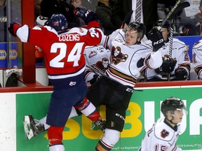 The Calgary Hitmen’s Luke Prokop battles the Lethbridge Hurricanes’ Dylan Cozens during their first-round WHL playoff series at the Scotiabank Saddledome in Calgary on March 28, 2019.