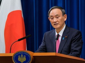 Japan's Prime Minister Suga Yoshihide delivers a speech during a news conference about the ongoing coronavirus disease (COVID-19) outbreak in Tokyo, Japan, December 25, 2020.
