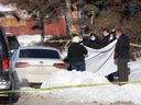 Calgary police at the scene where two men were found shot to death in a vehicle in Marlborough.  The men have been identified as Kuanyliet Kogalt and Garang Deng (Cody) Akoar.