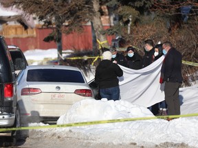 Calgary police on the scene where two men were found shot to death in a vehicle in Marlborough. The men have been identified as Kuanyliet Kogalt and Garang Deng (Cody) Akoar.