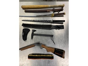 Okotoks RCMP have seized several weapons from the home of a man charged with shooting at a bailiff.