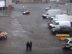 Screen grab from a security video showing a white pickup truck, pictured in the top right corner, just before it strikes a woman walking along a fence