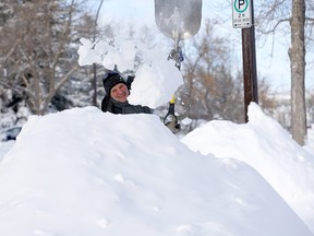 Ron Votek digs out of his Scenic Acres home as the city received massive amounts of snow overnight in Calgary on Tuesday, Dec. 22, 2020.