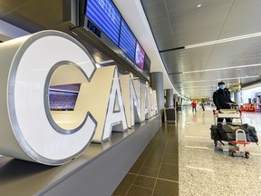 A traveller walks through Calgary International Airport on Wednesday, Dec. 30, 2020.