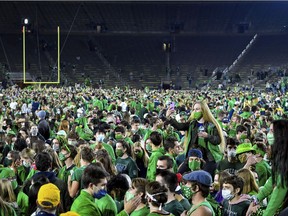 Fans storm the field after the Notre Dame Fighting Irish defeated the Clemson Tigers 47-40 in double overtime in an NCAA football game in South Bend, Ind., on Nov. 7, 2020.