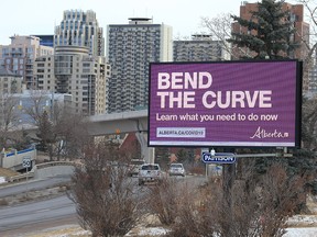 An electronic billboard displays Alberta COVID-19 information for drivers heading into downtown Calgary on Thursday, Dec. 17, 2020.