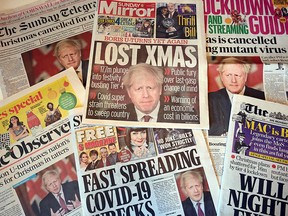 An arrangement of UK daily newspapers photographed in Liverpool on Dec. 20, 2020, shows front page headlines reporting on the story of Britain's Prime Minister Boris Johnson introducing new tougher coronavirus COVID-19 restrictions.