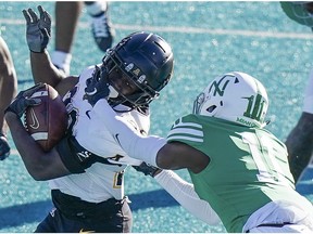 Dec 21, 2020; Conway, SC, USA; Appalachian State Mountaineers running back Nate Noel (20) is grabbed by the face mask by North Texas Mean Green defensive back Cam Johnson (11) at Brooks Stadium. Mandatory Credit: David Yeazell-USA TODAY Sports ORG XMIT: IMAGN-439084