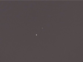 Jupiter (below) and Saturn (above) are pictured on the sky during the closest visible conjunction of them in 400 years, in Kathmandu, Nepal December 21, 2020.