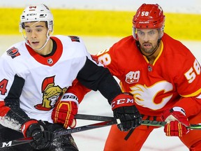 Ottawa Senators  J.C. Beaudin fights for position against Oliver Kylington of the Calgary Flames during NHL hockey in Calgary on Saturday November 30, 2019. Al Charest / Postmedia
