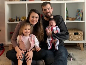 The Forrest family, Ceyda, Ben, Hazel, 20 months, and newborn Nora pose for a photo after Nora was released form the hospital. Nora tested positive for COVID-19 just days after her birth and had to stay on a breathing tube for three days.