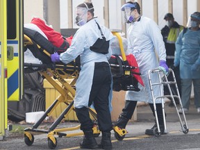 Paramedics transfer a patient from Maimonides Geriatric Centre in Montreal on Nov. 29, 2020.