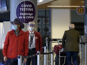 Travellers arriving at Calgary International Airport are guided to the COVID-19 testing location on Wednesday, Dec. 30, 2020.