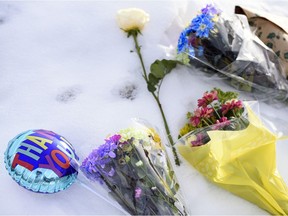 On Friday, January 1, 2021, flowers are left at the location where Sgt. Andrews Harnett with the Calgary Police Services was killed last night after he was struck by a fleeing vehicle at a traffic stop in Falconridge. Azin Ghaffari/Postmedia
