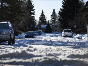 Weeks after the last heavy snowfall, piles of snow in some Calgary streets makes it difficult for drivers to reach the main streets on Thursday, Jan. 7, 2021. Pictured is a street in the northwest community of Varsity.