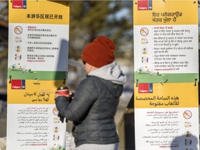 Multi-language signs by City of Calgary are seen encouraging Calgarians to maintain physical distancing at Prairie Winds Park in Northeast Calgary on Thursday, January 14, 2021.