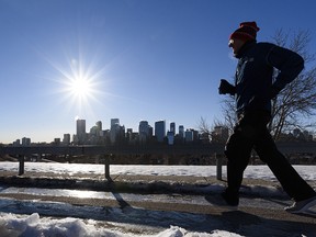 A jogger braves the cold for a morning workout on the Crescent Heights pathway on Friday, January 22, 2021.