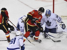 A shot from the Calgary Flames’ Sean Monahan is saved by Toronto Maple Leafs goalie Jack Campbell at the Saddledome in Calgary on Sunday, Jan. 24, 2021.