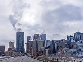 A dimmed sun shines above the high-rises in Calgary skyline on a cold day of -15 on Tuesday, Jan. 26, 2021.